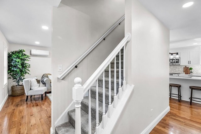 105 Forest Ave, Warren, MA 01585 - stairs featuring a wall mounted air conditioner, recessed lighting, and wood finished floors