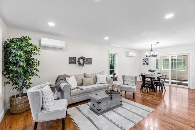 105 Forest Ave, Warren, MA 01585 - living room featuring a wall mounted AC, a wall unit AC, a chandelier, wood finished floors, and recessed lighting