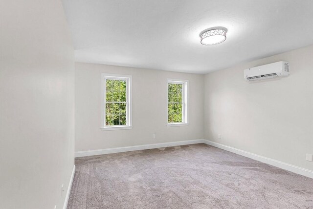 105 Forest Ave, Warren, MA 01585 - carpeted empty room with a wall mounted AC and baseboards