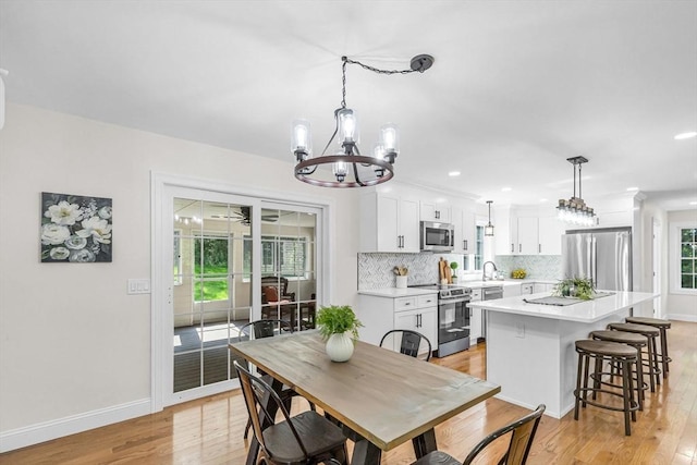 105 Forest Ave, Warren, MA 01585 - dining area with a chandelier, light wood-type flooring, and recessed lighting