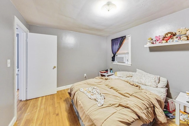 bedroom featuring light hardwood / wood-style floors and cooling unit