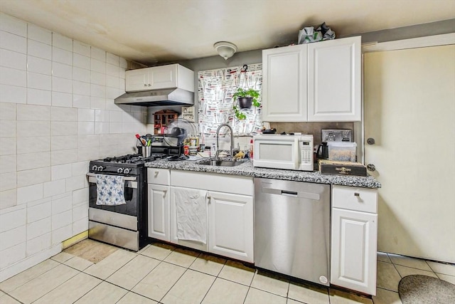 kitchen featuring light tile patterned flooring, sink, white cabinetry, and stainless steel appliances