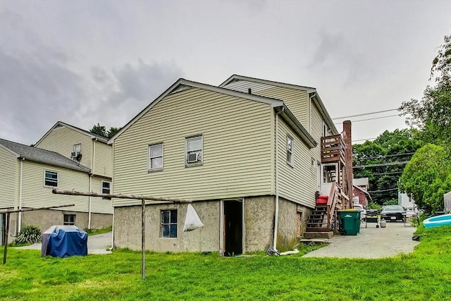 rear view of house featuring a lawn