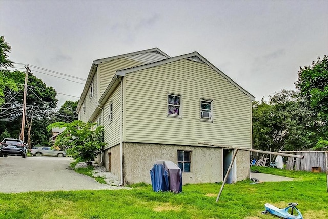 view of side of home featuring a lawn