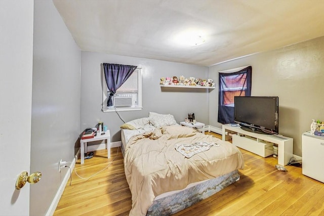 bedroom featuring cooling unit and wood-type flooring