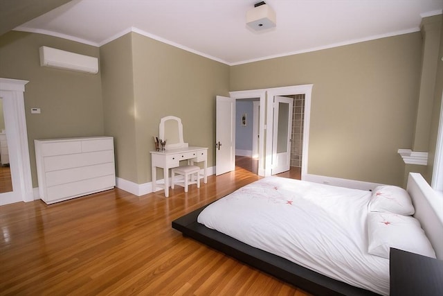 175 Winthrop Rd Unit 3, Brookline, MA 02445 - bedroom with a wall unit AC, wood finished floors, and crown molding