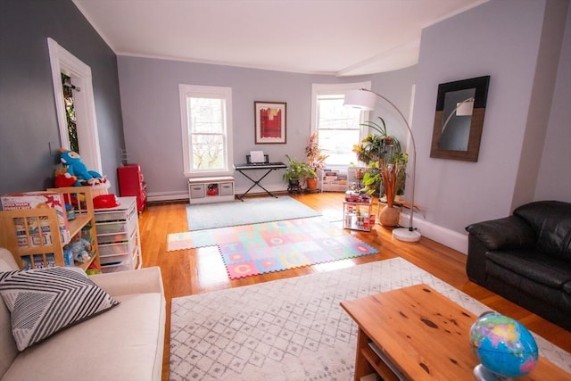 175 Winthrop Rd Unit 3, Brookline, MA 02445 - living area with wood finished floors, a baseboard heating unit, and ornamental molding