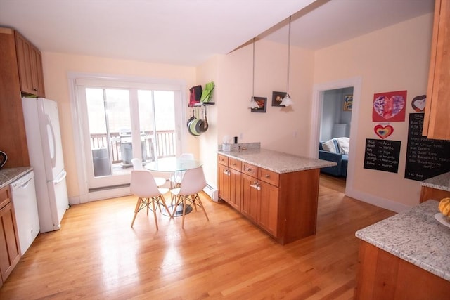 175 Winthrop Rd Unit 3, Brookline, MA 02445 - kitchen with brown cabinetry, white appliances, light wood finished floors, a baseboard heating unit, and light stone countertops