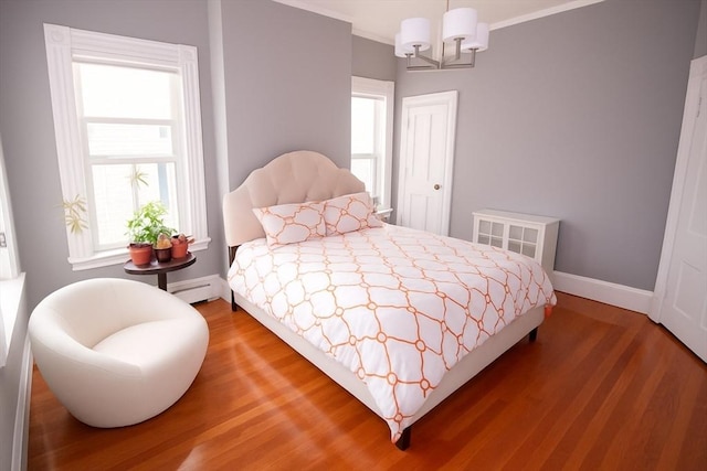 175 Winthrop Rd Unit 3, Brookline, MA 02445 - bedroom featuring baseboard heating, wood finished floors, a chandelier, and ornamental molding