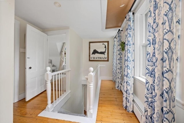 22 High St, Hingham, MA 02043 - hallway with an upstairs landing, light wood finished floors, baseboard heating, and baseboards