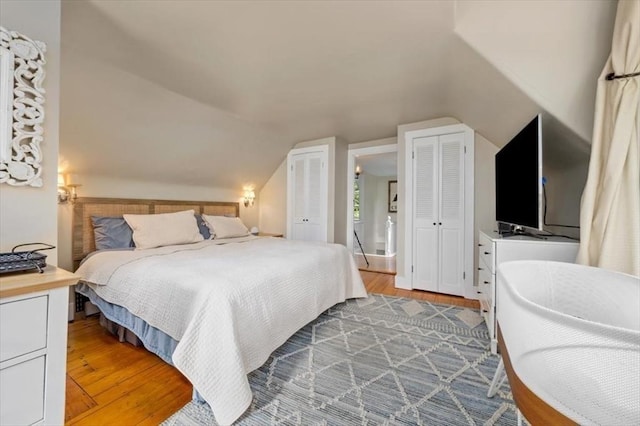 22 High St, Hingham, MA 02043 - bedroom featuring multiple closets, wood finished floors, and vaulted ceiling