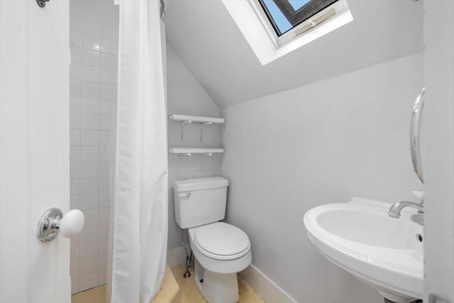 22 High St, Hingham, MA 02043 - bathroom with a skylight, toilet, lofted ceiling, tiled shower, and a sink