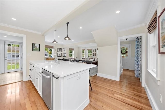 22 High St, Hingham, MA 02043 - kitchen with stainless steel dishwasher, light wood finished floors, crown molding, white cabinetry, and baseboards