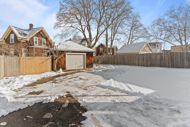 yard layered in snow with a garage