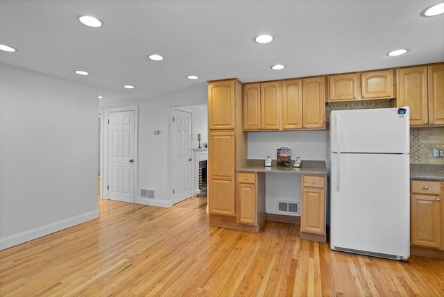 kitchen with freestanding refrigerator, recessed lighting, visible vents, and light wood-style floors