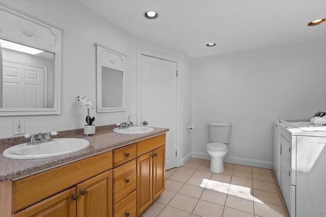 full bath featuring a sink, tile patterned flooring, double vanity, and independent washer and dryer
