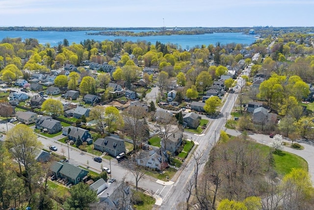 drone / aerial view with a water view and a residential view