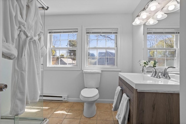 bathroom with tile patterned flooring, vanity, toilet, baseboards, and baseboard heating