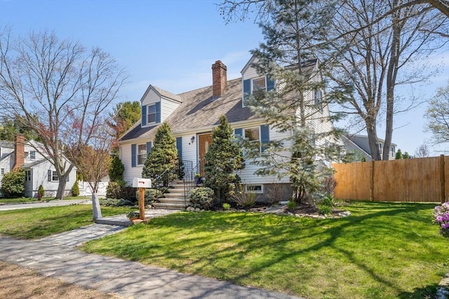 cape cod home with a chimney, fence, and a front yard