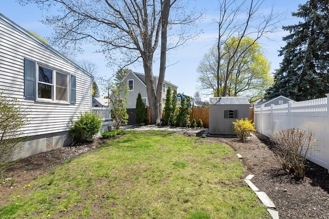 view of yard with a storage unit, a fenced backyard, and an outdoor structure