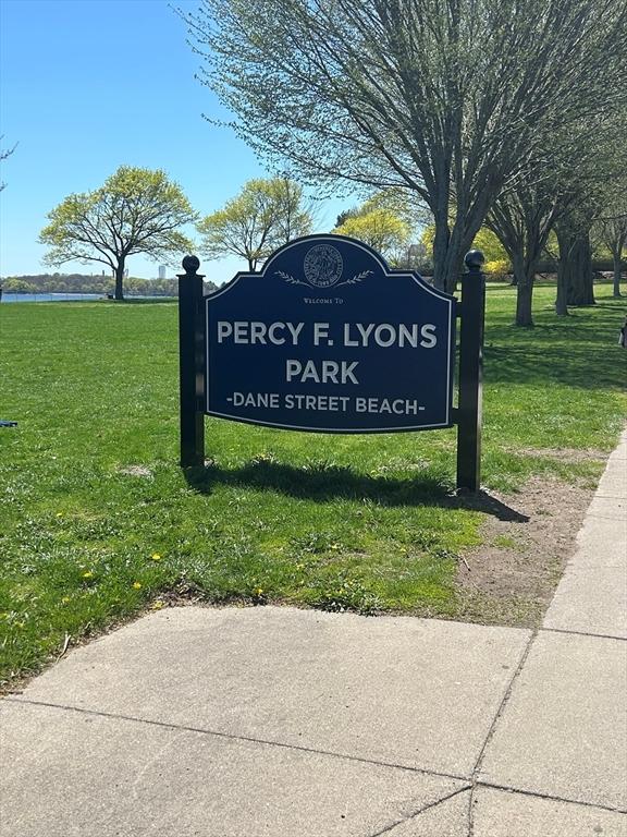 community / neighborhood sign with a yard