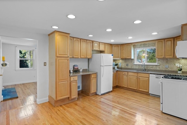 kitchen featuring white appliances, recessed lighting, a wealth of natural light, and a sink