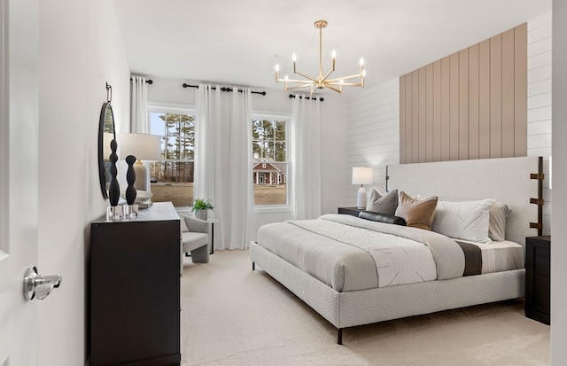 bedroom featuring a chandelier, carpet, and wooden walls