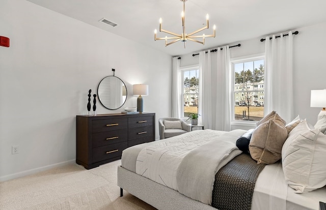 carpeted bedroom featuring an inviting chandelier