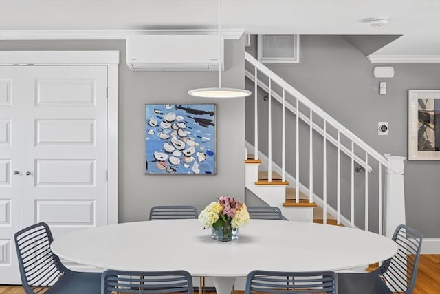53 W Vine St Unit A, Provincetown, MA 02657 - dining space with an AC wall unit, ornamental molding, stairs, and wood finished floors
