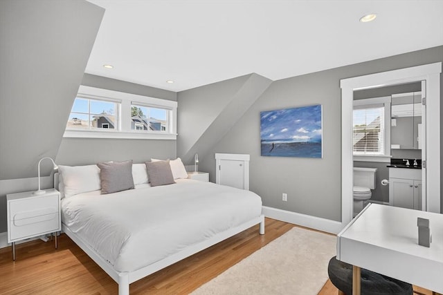 53 W Vine St Unit A, Provincetown, MA 02657 - bedroom with light wood finished floors, recessed lighting, and connected bathroom