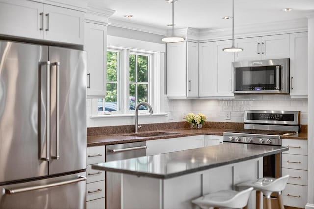 53 W Vine St Unit A, Provincetown, MA 02657 - kitchen with stainless steel appliances, white cabinetry, backsplash, and ornamental molding