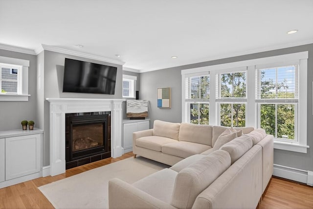 53 W Vine St Unit A, Provincetown, MA 02657 - living area featuring healthy amount of natural light, ornamental molding, light wood-type flooring, a glass covered fireplace, and recessed lighting