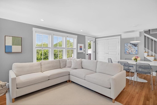 53 W Vine St Unit A, Provincetown, MA 02657 - living area with a wall unit AC, stairway, wood finished floors, and recessed lighting
