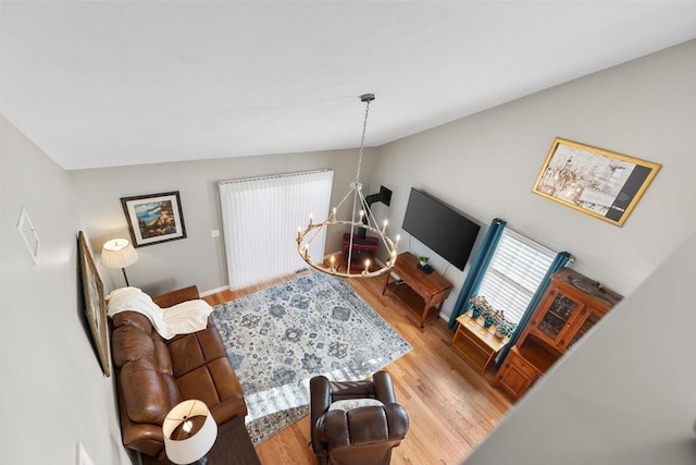 living room with hardwood / wood-style flooring and a notable chandelier