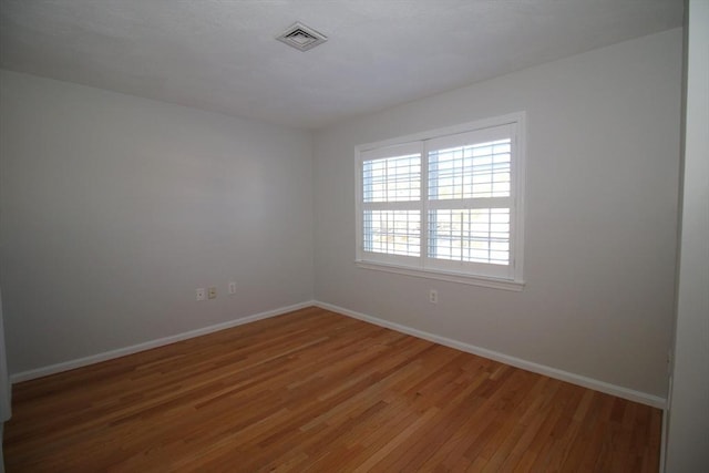 spare room featuring hardwood / wood-style flooring