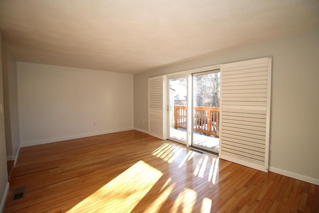 spare room with hardwood / wood-style flooring