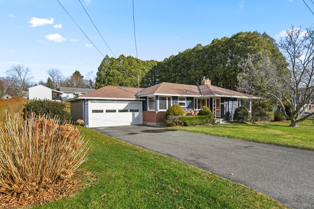 ranch-style house with a front yard and a garage