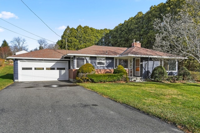 ranch-style house with a garage and a front lawn