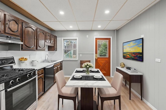 309 E Eagle St, Boston, MA 02128 - kitchen featuring stainless steel range with gas stovetop, dishwasher, under cabinet range hood, a sink, and light wood-style flooring