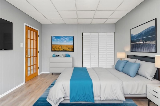 309 E Eagle St, Boston, MA 02128 - bedroom featuring a paneled ceiling, a closet, wood finished floors, and baseboards