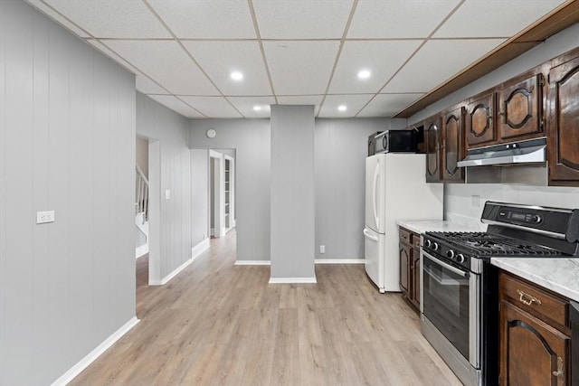 309 E Eagle St, Boston, MA 02128 - kitchen with stainless steel appliances, under cabinet range hood, light wood finished floors, dark brown cabinets, and recessed lighting