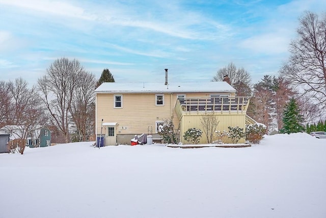 view of snow covered back of property