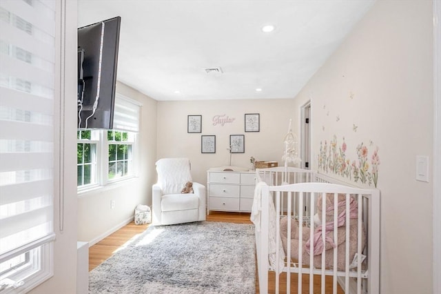 47 Patrick Rd Unit 47, Tewksbury, MA 01876 - bedroom featuring wood finished floors, a crib, recessed lighting, and baseboards