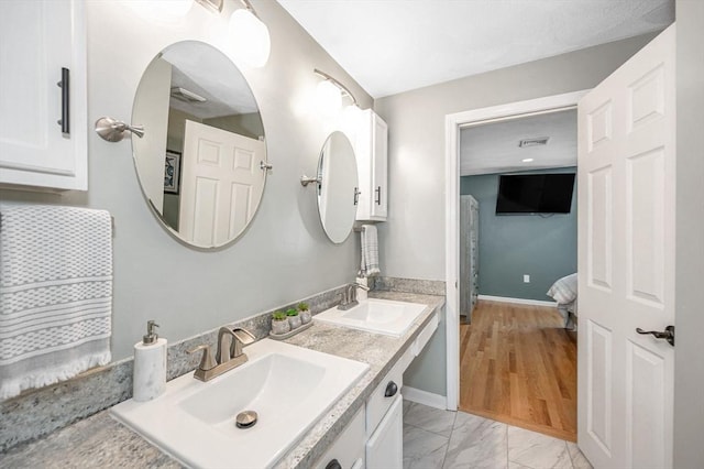 47 Patrick Rd Unit 47, Tewksbury, MA 01876 - full bath featuring double vanity, ensuite bath, marble look tile flooring, and baseboards