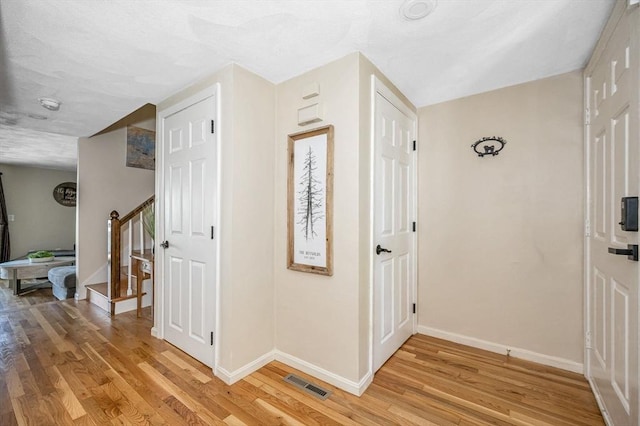 47 Patrick Rd Unit 47, Tewksbury, MA 01876 - corridor with light wood-type flooring, baseboards, and stairway