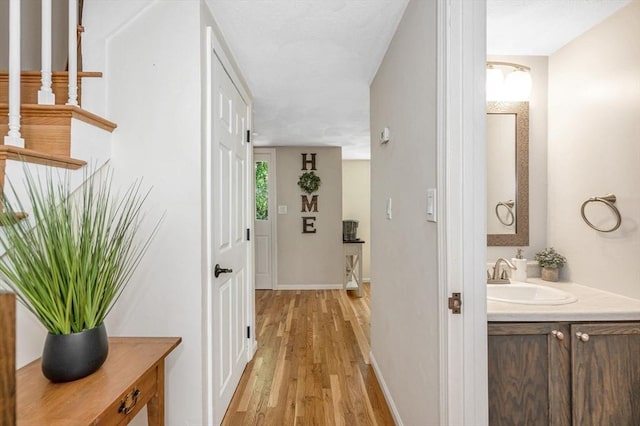 47 Patrick Rd Unit 47, Tewksbury, MA 01876 - hall with a sink, light wood finished floors, and baseboards