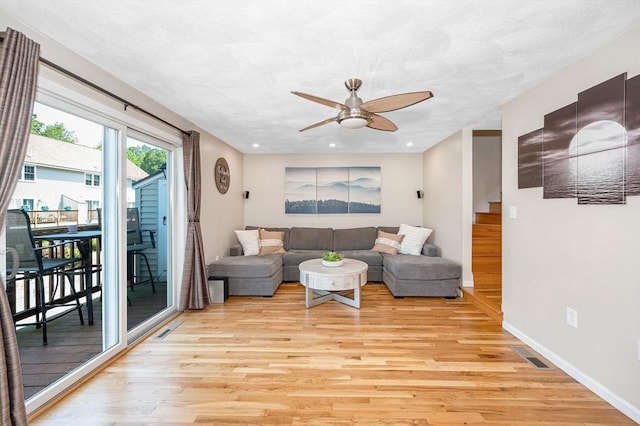 47 Patrick Rd Unit 47, Tewksbury, MA 01876 - living room featuring light wood-style floors, ceiling fan, stairs, and baseboards