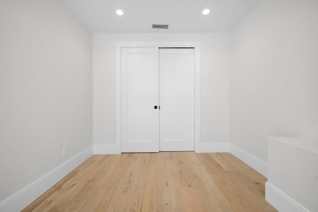 unfurnished bedroom featuring a closet and light hardwood / wood-style flooring