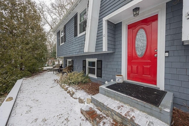 view of snow covered property entrance