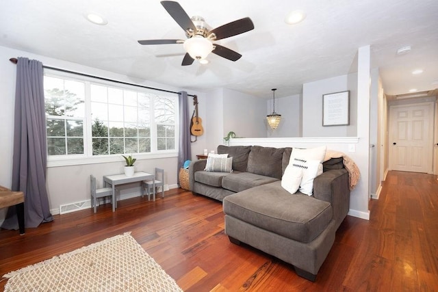 living room with dark hardwood / wood-style floors, a healthy amount of sunlight, and ceiling fan